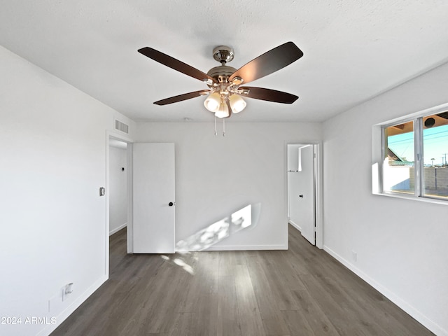 spare room featuring ceiling fan and dark hardwood / wood-style flooring