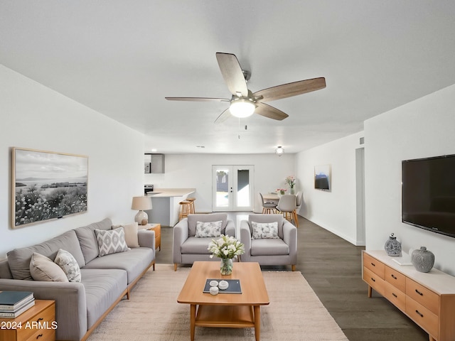 living room featuring ceiling fan, dark hardwood / wood-style floors, and french doors