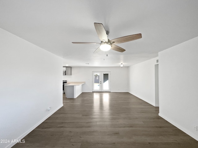 unfurnished living room with french doors, ceiling fan, and dark hardwood / wood-style flooring