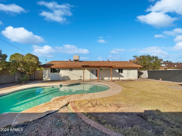 view of swimming pool featuring a lawn and a patio