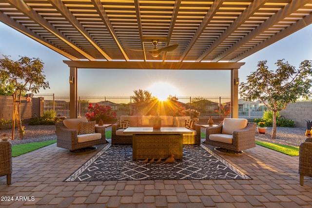 patio terrace at dusk featuring a pergola and an outdoor hangout area