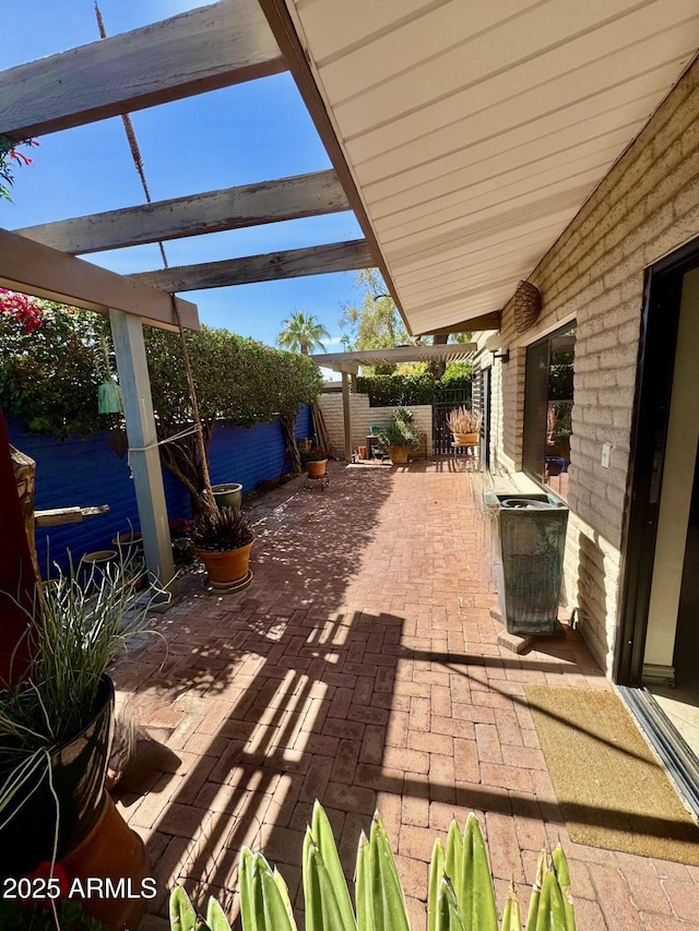 view of patio / terrace featuring fence and a pergola