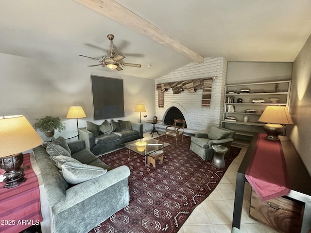 tiled living area with a brick fireplace, vaulted ceiling with beams, and ceiling fan