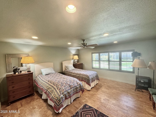 bedroom with recessed lighting, baseboards, and a textured ceiling