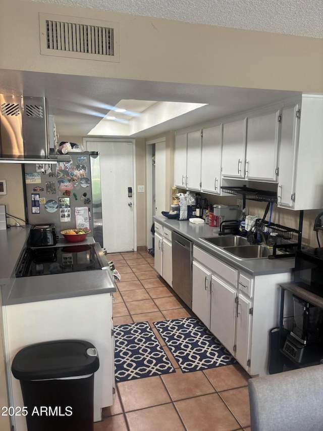 8653 S 51st St Unit 2, Phoenix, AZ 85044 - kitchen with appliances with stainless steel finishes, a sink, light tile patterned floors, and white cabinetry