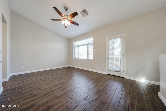 unfurnished room with visible vents, a ceiling fan, dark wood-style floors, baseboards, and lofted ceiling