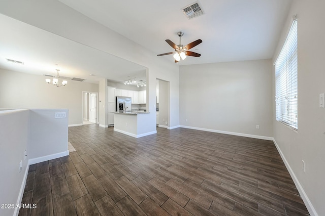 unfurnished living room with visible vents, baseboards, dark wood-style floors, and ceiling fan with notable chandelier