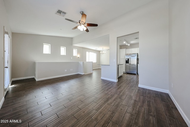 unfurnished living room with visible vents, baseboards, dark wood-style floors, and a ceiling fan