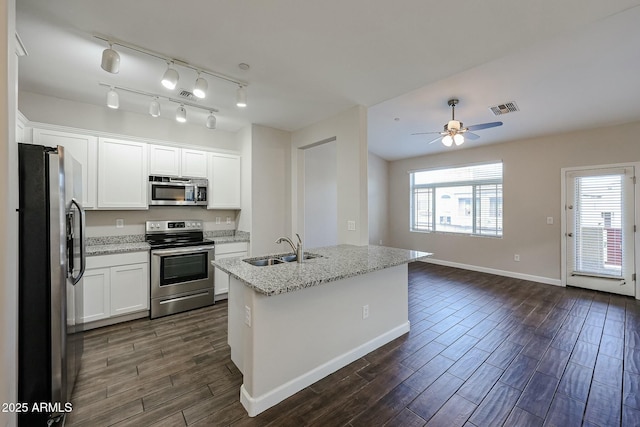 kitchen featuring visible vents, a sink, plenty of natural light, appliances with stainless steel finishes, and wood tiled floor