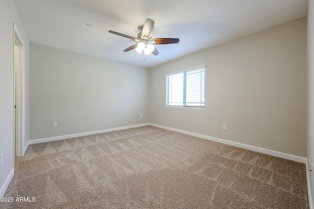 unfurnished room with a ceiling fan, baseboards, and light carpet