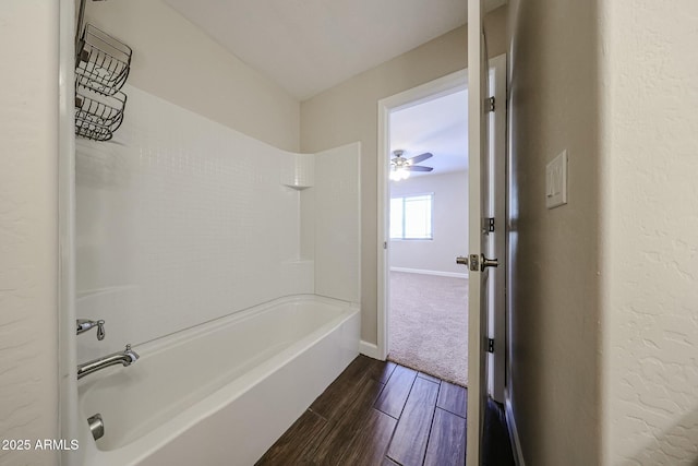 full bathroom featuring ceiling fan, baseboards,  shower combination, and wood finish floors