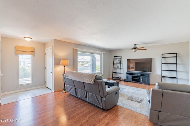 living room featuring ceiling fan and light hardwood / wood-style floors