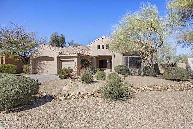 view of front of house with a garage, driveway, a tile roof, and stucco siding