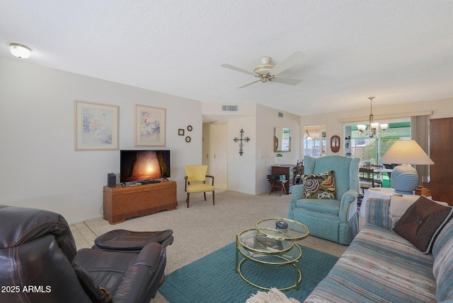 living room featuring ceiling fan with notable chandelier, light colored carpet, and a textured ceiling