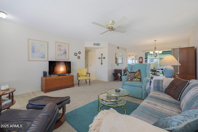 living room with ceiling fan with notable chandelier, a textured ceiling, and light tile patterned floors