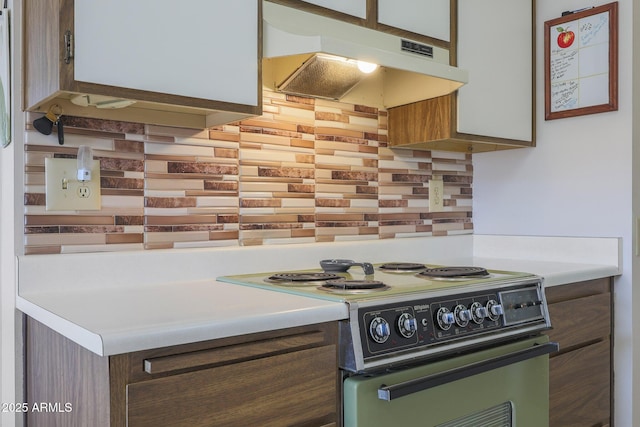 kitchen with tasteful backsplash and electric range