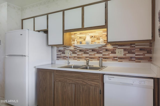 kitchen featuring white cabinetry, sink, white appliances, and decorative backsplash