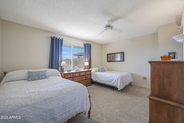 bedroom featuring ceiling fan, carpet flooring, and a textured ceiling