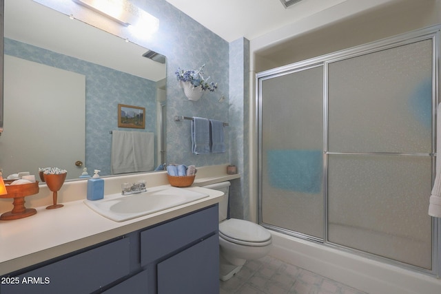 bathroom with vanity, an enclosed shower, and toilet