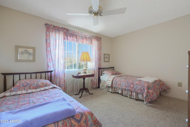 carpeted bedroom with ceiling fan and a textured ceiling