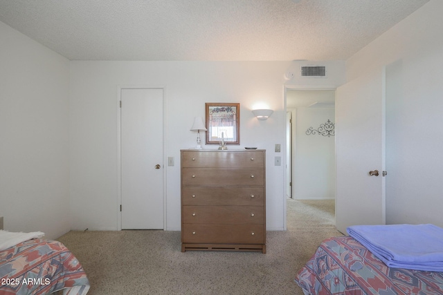 carpeted bedroom featuring a textured ceiling