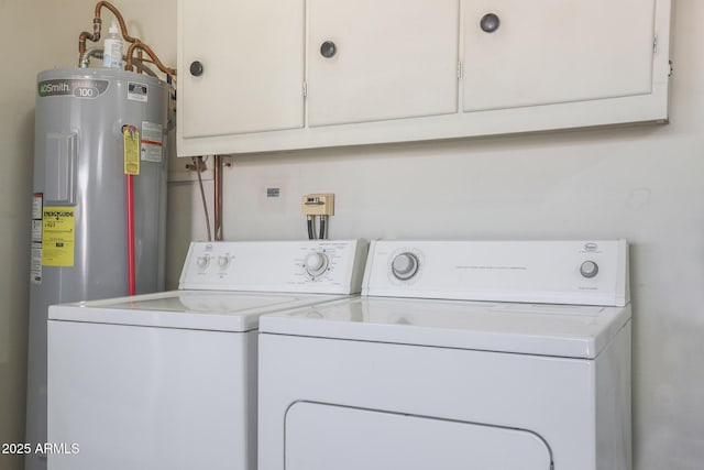 laundry room featuring cabinets, separate washer and dryer, and water heater