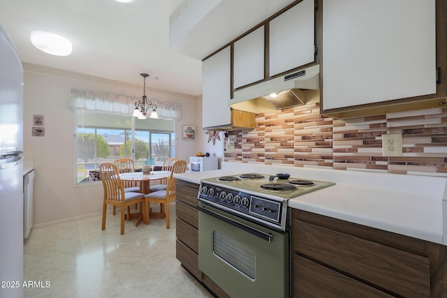 kitchen featuring electric range oven, decorative light fixtures, decorative backsplash, and white cabinets