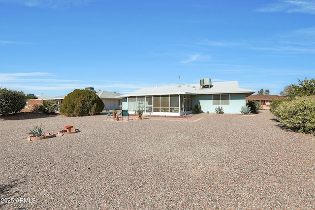 back of property featuring central AC, a patio area, and a sunroom