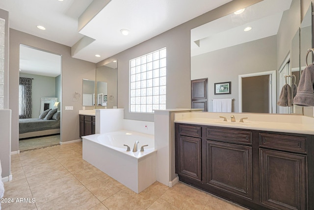 bathroom with vanity, tile patterned flooring, and a tub