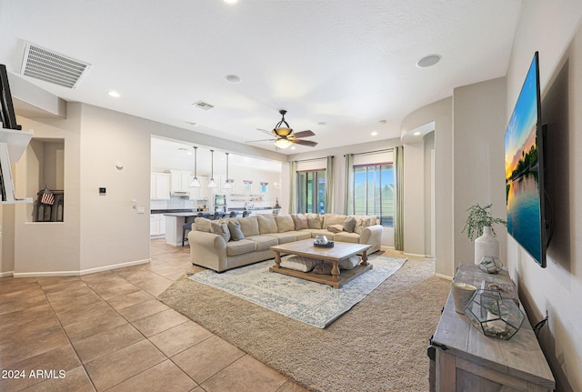 living room featuring ceiling fan and light tile patterned floors