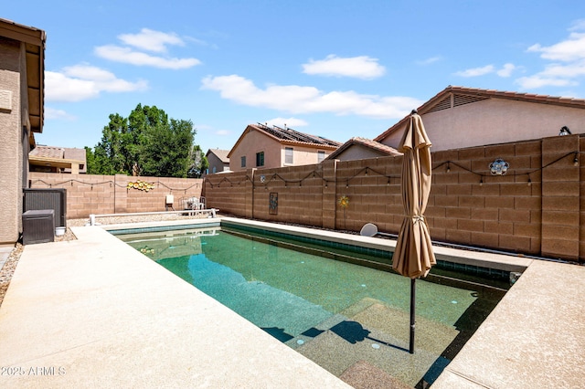 view of pool with a patio, central AC, a fenced in pool, and a fenced backyard
