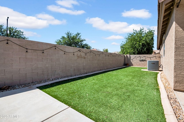 view of yard featuring a patio, central AC unit, and a fenced backyard