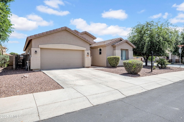 ranch-style home featuring stucco siding, a gate, an attached garage, driveway, and a tile roof