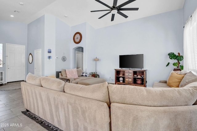 living room with ceiling fan, arched walkways, high vaulted ceiling, recessed lighting, and visible vents