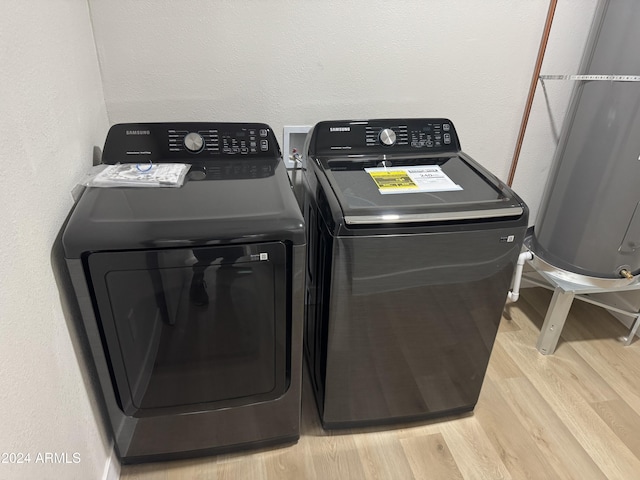 washroom featuring light wood-type flooring and washer and clothes dryer