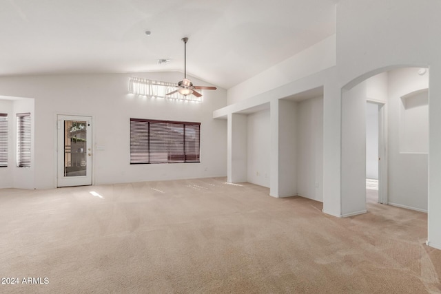 unfurnished living room with ceiling fan, light carpet, and high vaulted ceiling