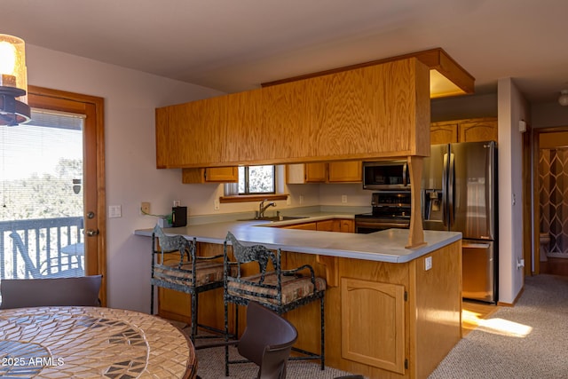 2806 Skyhawk Dr, Overgaard, AZ 85933 - kitchen with appliances with stainless steel finishes, a sink, a peninsula, light countertops, and light colored carpet