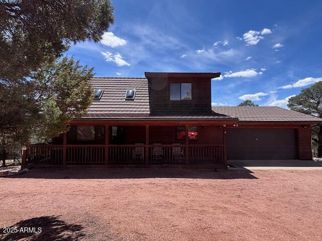 2806 Skyhawk Dr, Overgaard, AZ 85933 - view of front of property with an attached garage, driveway, and a porch