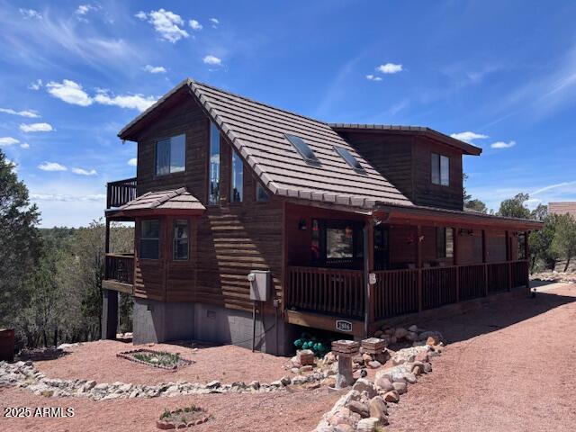 2806 Skyhawk Dr, Overgaard, AZ 85933 - view of front of house with a porch and a tile roof