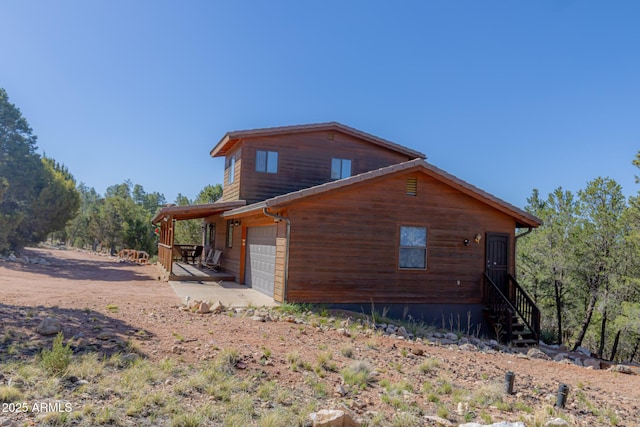 2806 Skyhawk Dr, Overgaard, AZ 85933 - view of side of home with dirt driveway and an attached garage