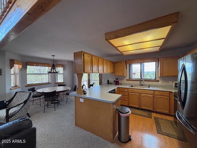 2806 Skyhawk Dr, Overgaard, AZ 85933 - kitchen featuring freestanding refrigerator, a sink, a peninsula, and healthy amount of natural light
