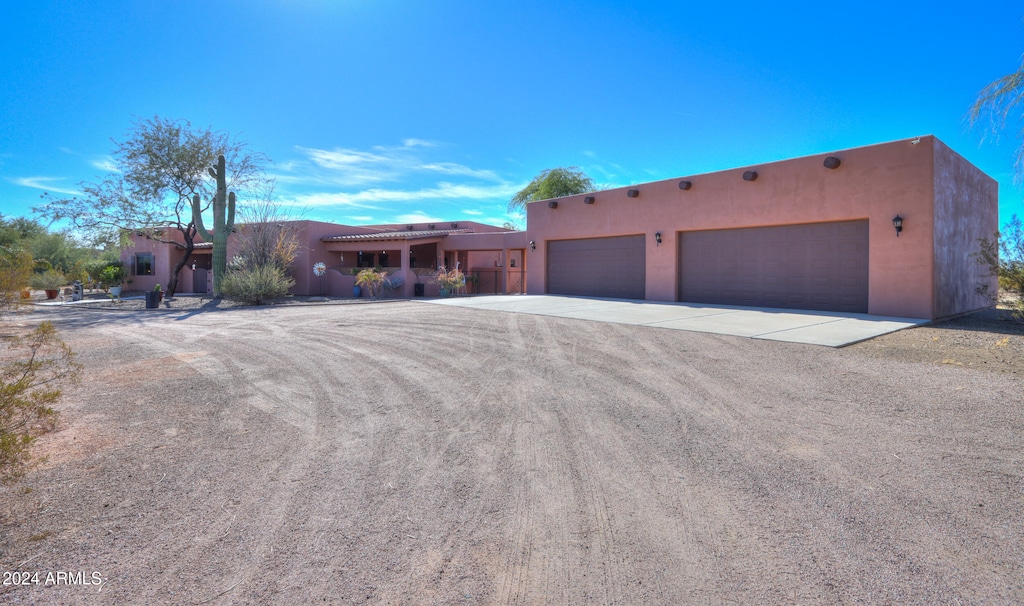 pueblo-style house with a garage