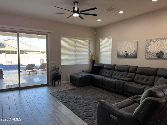 living room featuring ceiling fan and wood-type flooring