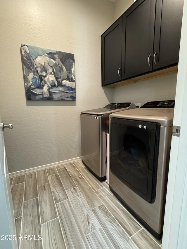 laundry area featuring cabinets and independent washer and dryer