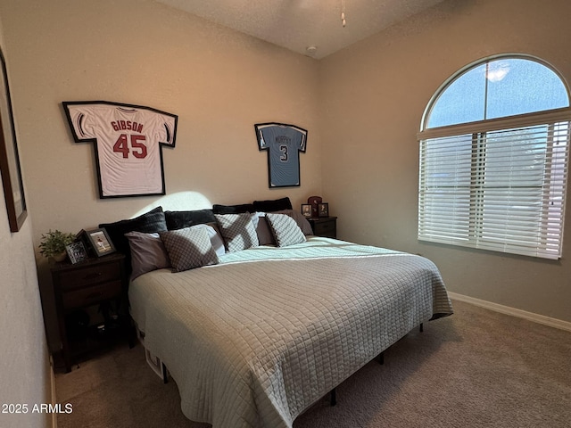 carpeted bedroom with vaulted ceiling