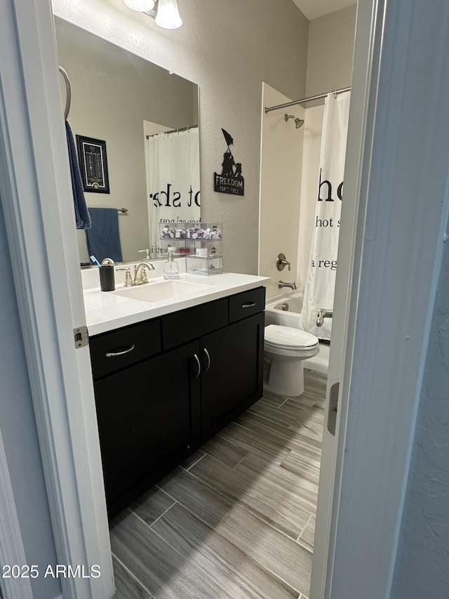 full bathroom featuring shower / bath combo, vanity, and toilet