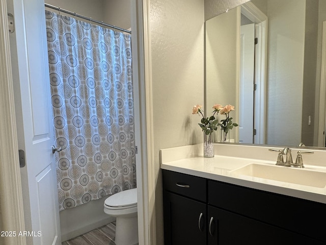 full bathroom featuring vanity, shower / tub combo, and toilet