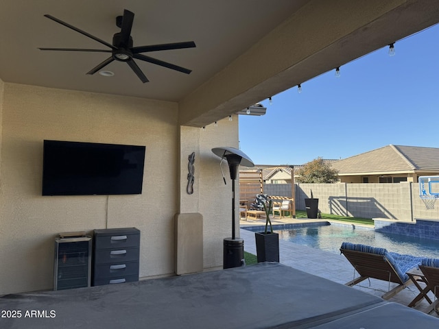 view of pool with ceiling fan and a patio area