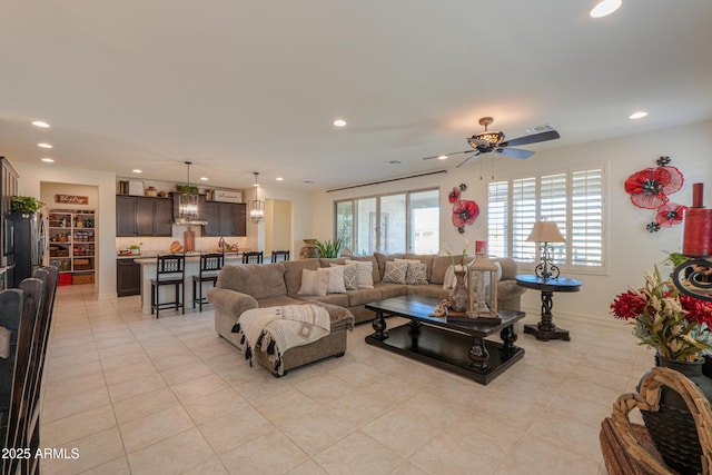 tiled living room featuring ceiling fan