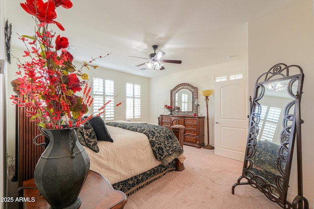 bedroom featuring light carpet and ceiling fan